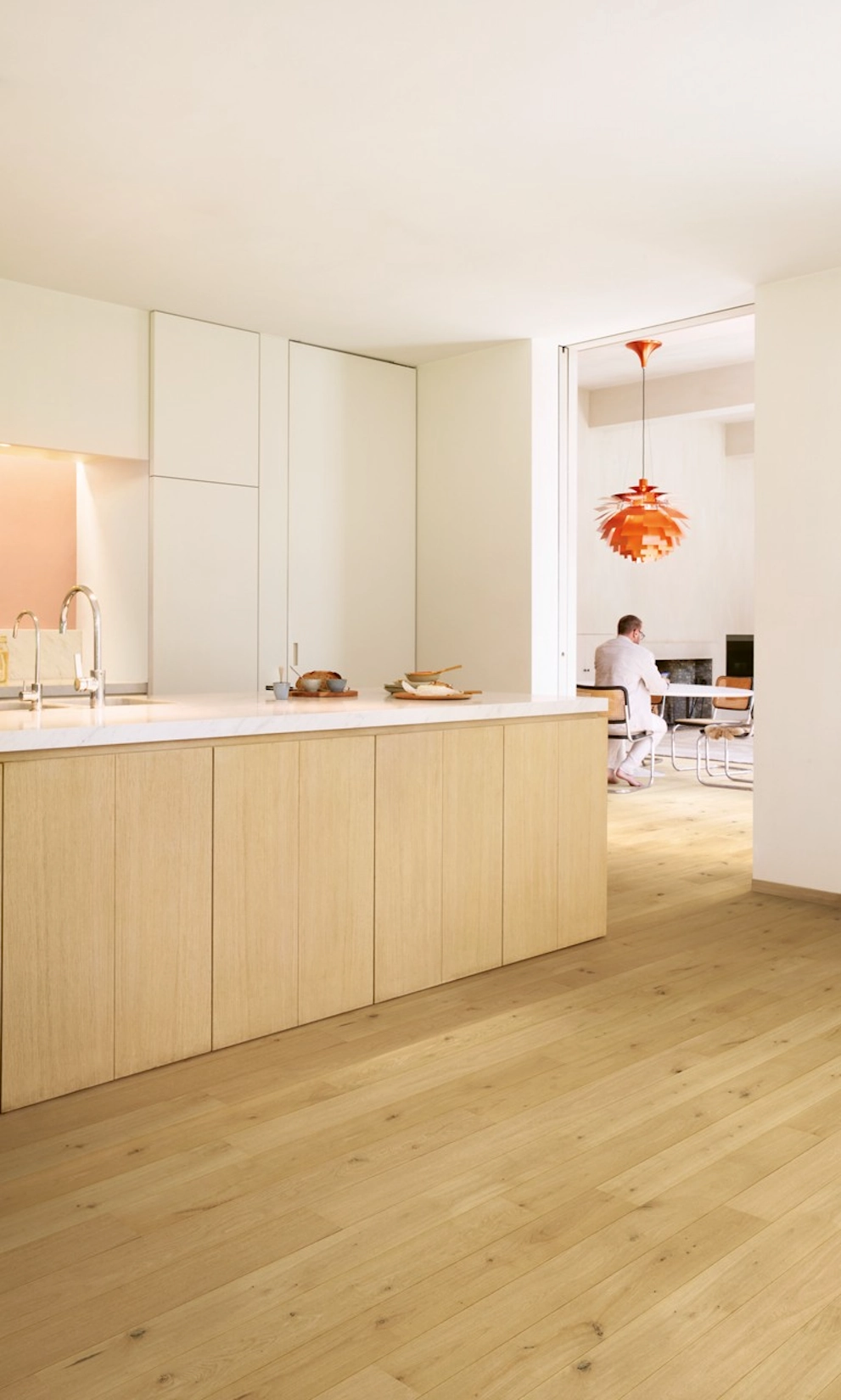 Slab kitchen in pale oak with island and herringbone flooring