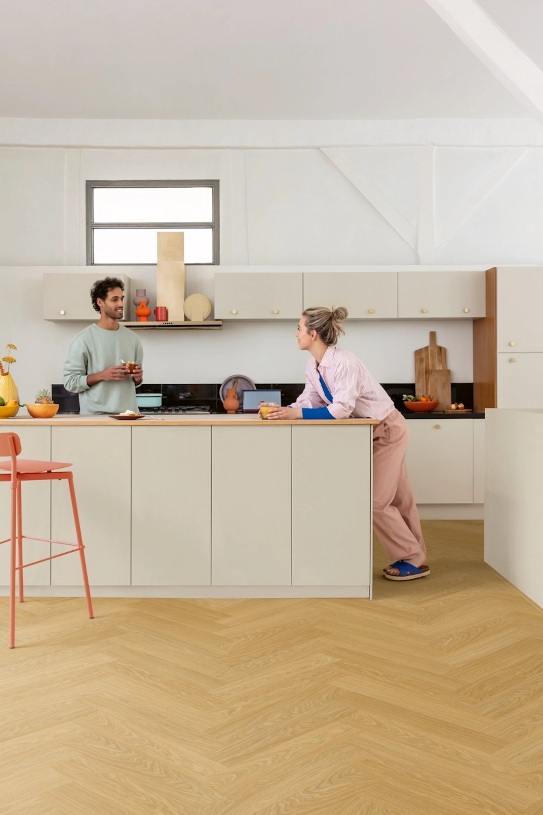 Cream slab kitchen with island and herringbone oak flooring