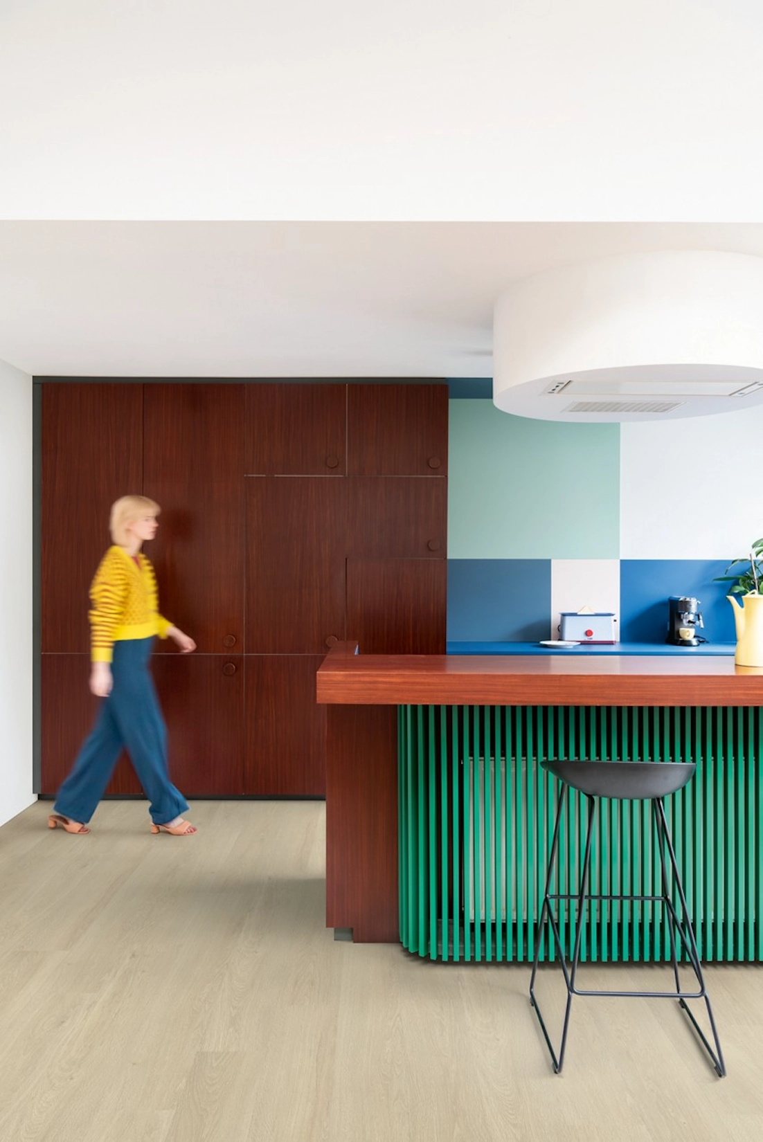 Slab kitchen with red and green island and breakfast stools