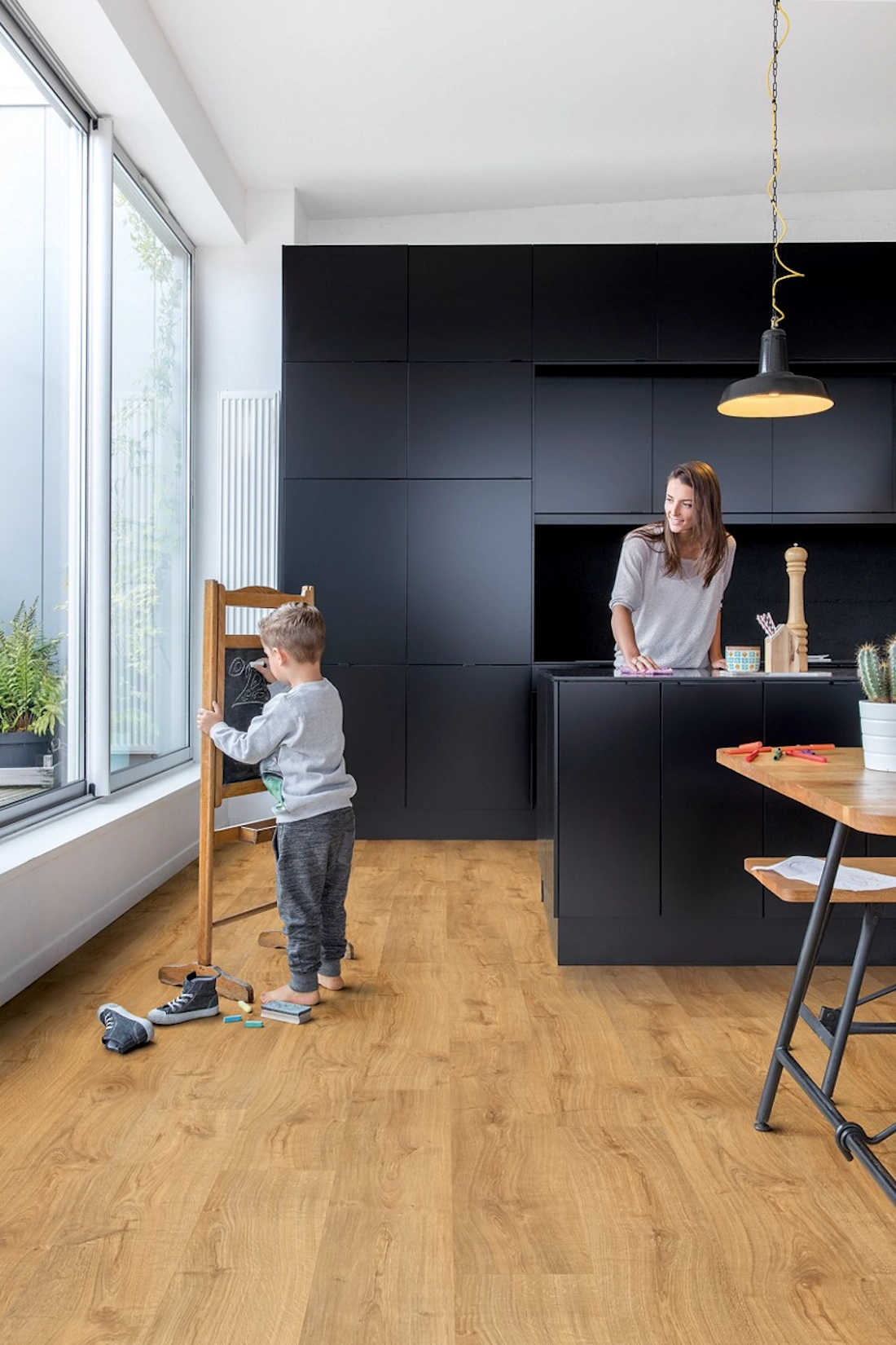 Navy slab kitchen with oak flooring and full height windows
