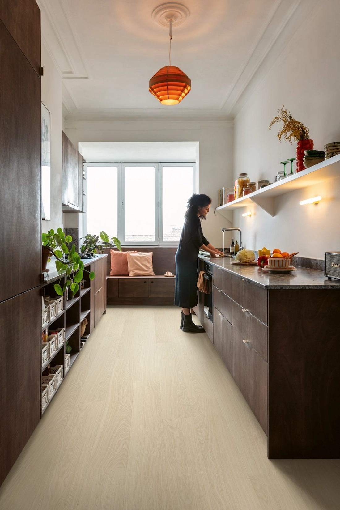 Galley slab kitchen in dark timber with pendant light