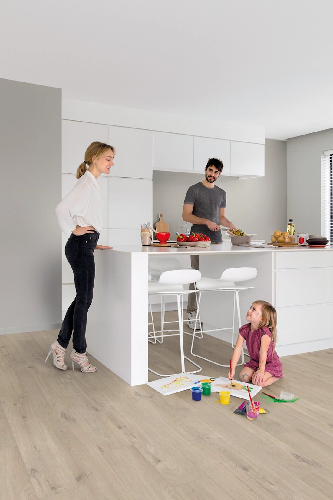 Family cooking together in a white handleless kitchen with island