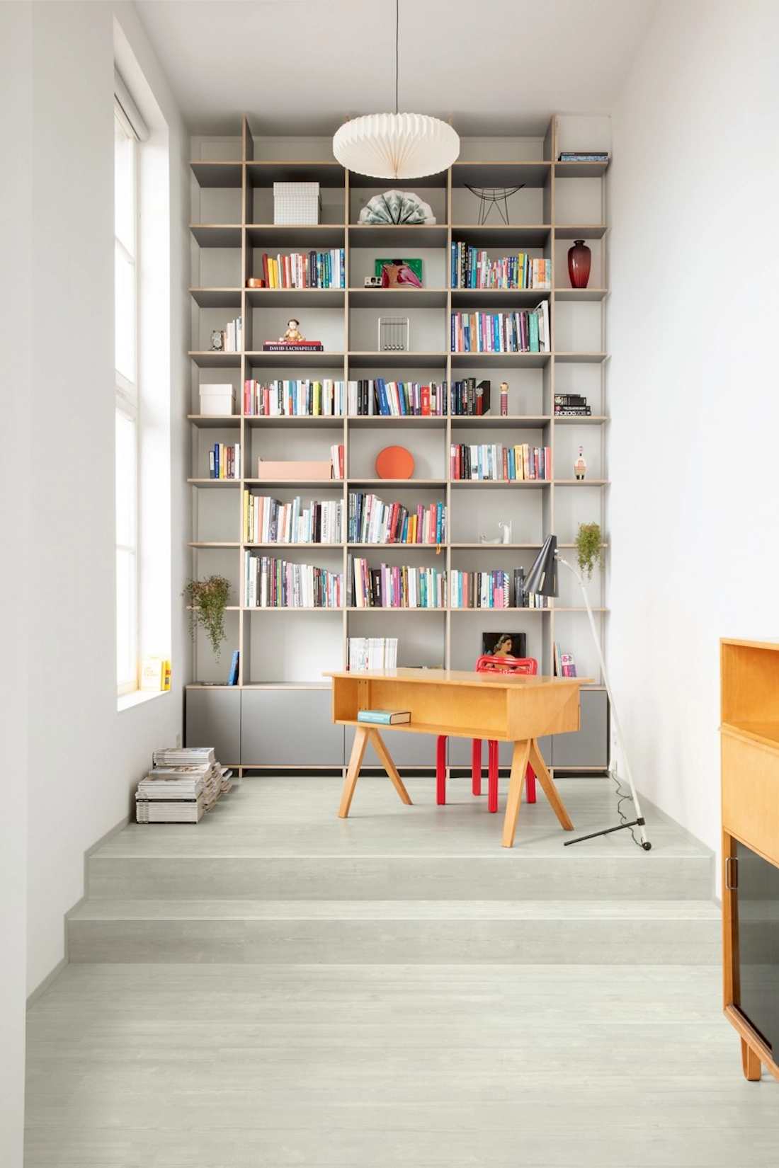 Home office with floor to ceiling bookshelves and writing desk