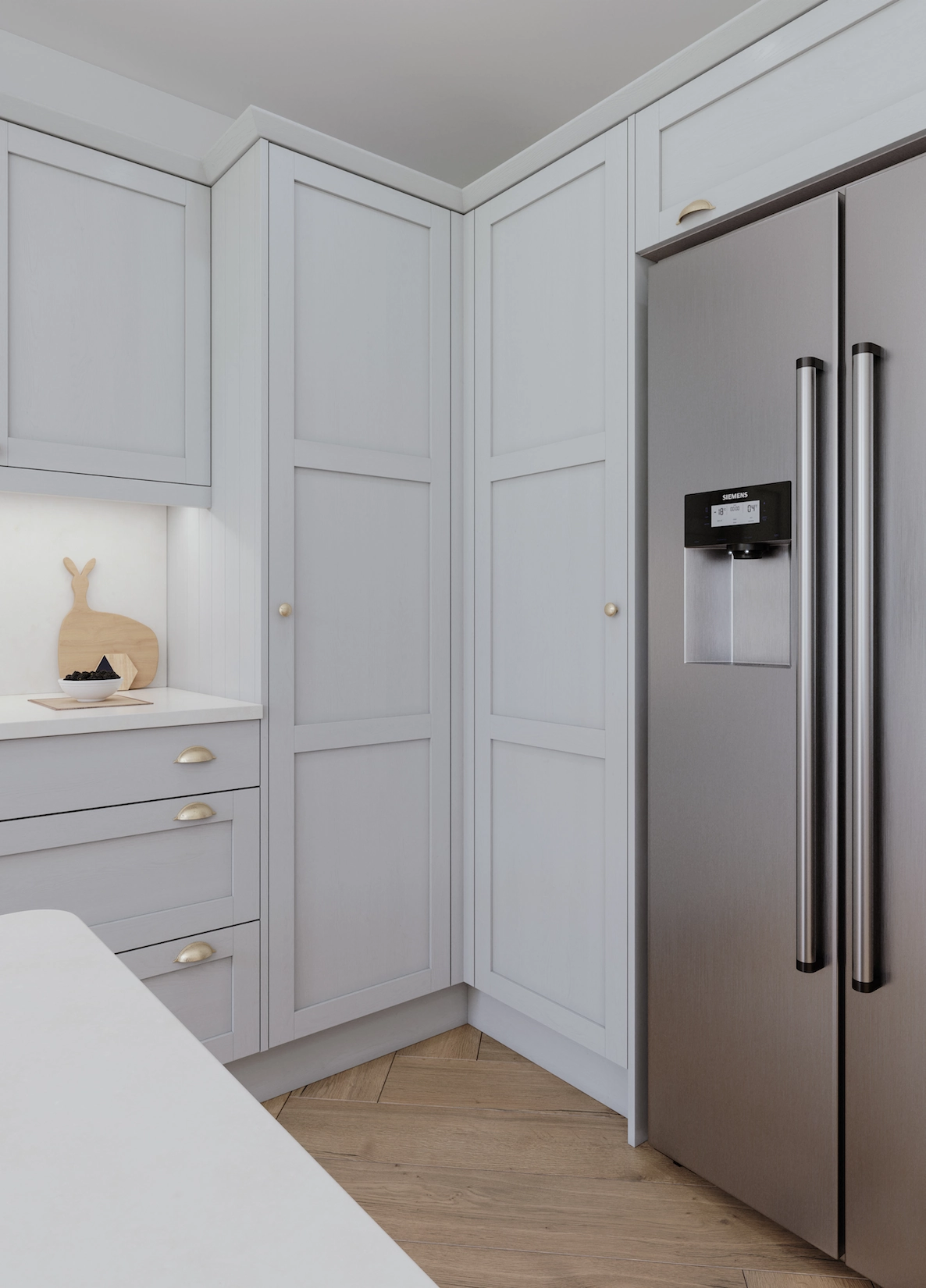 Pale grey shaker tall units with American style fridge freezer