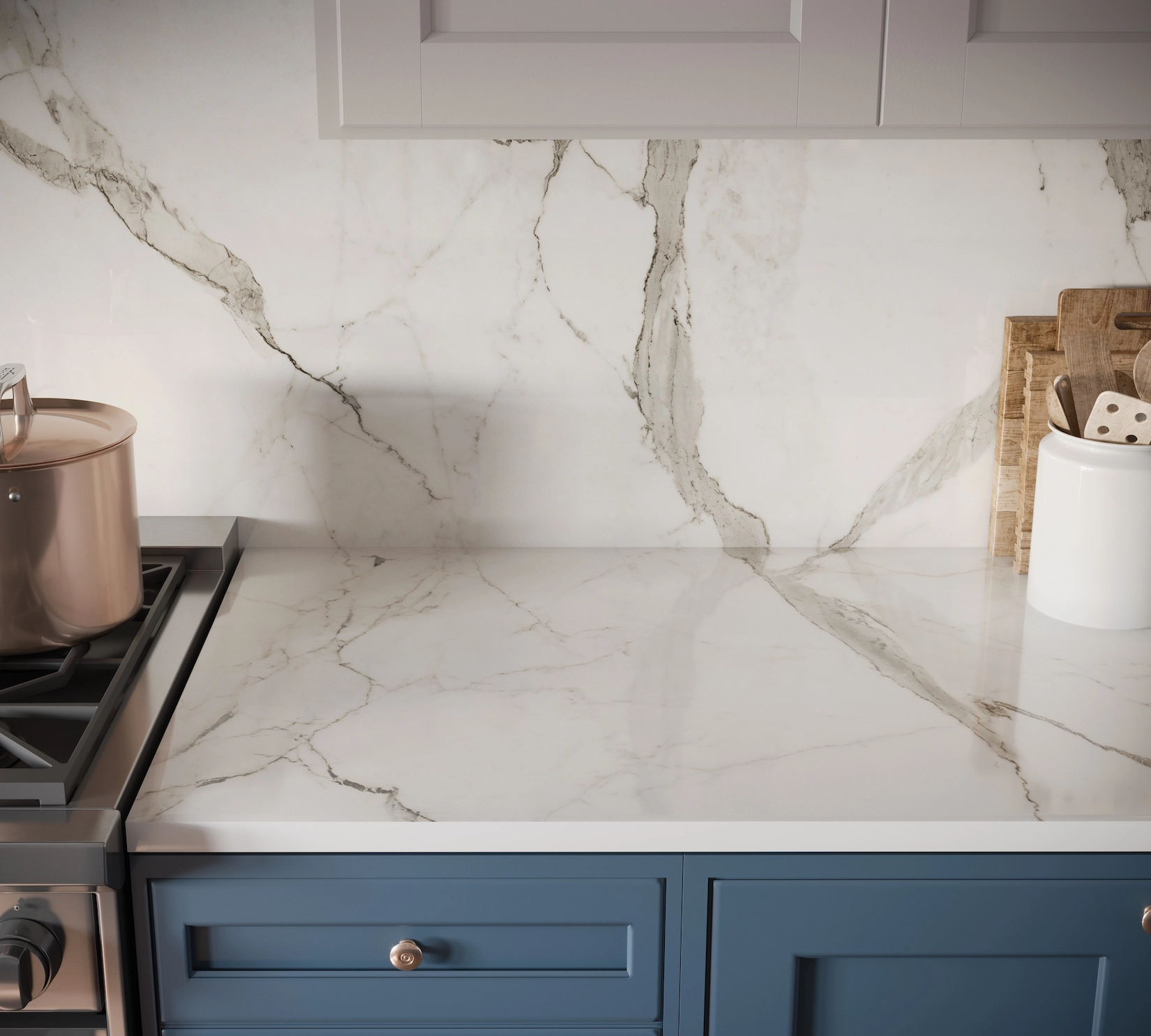 Marble splashback above navy shaker cabinets and range cooker