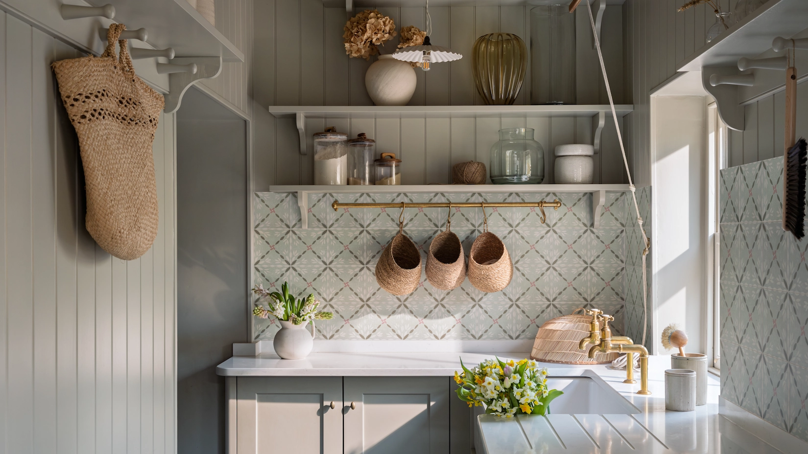 Utility room with butler sink, open shelving and patterned splashback
