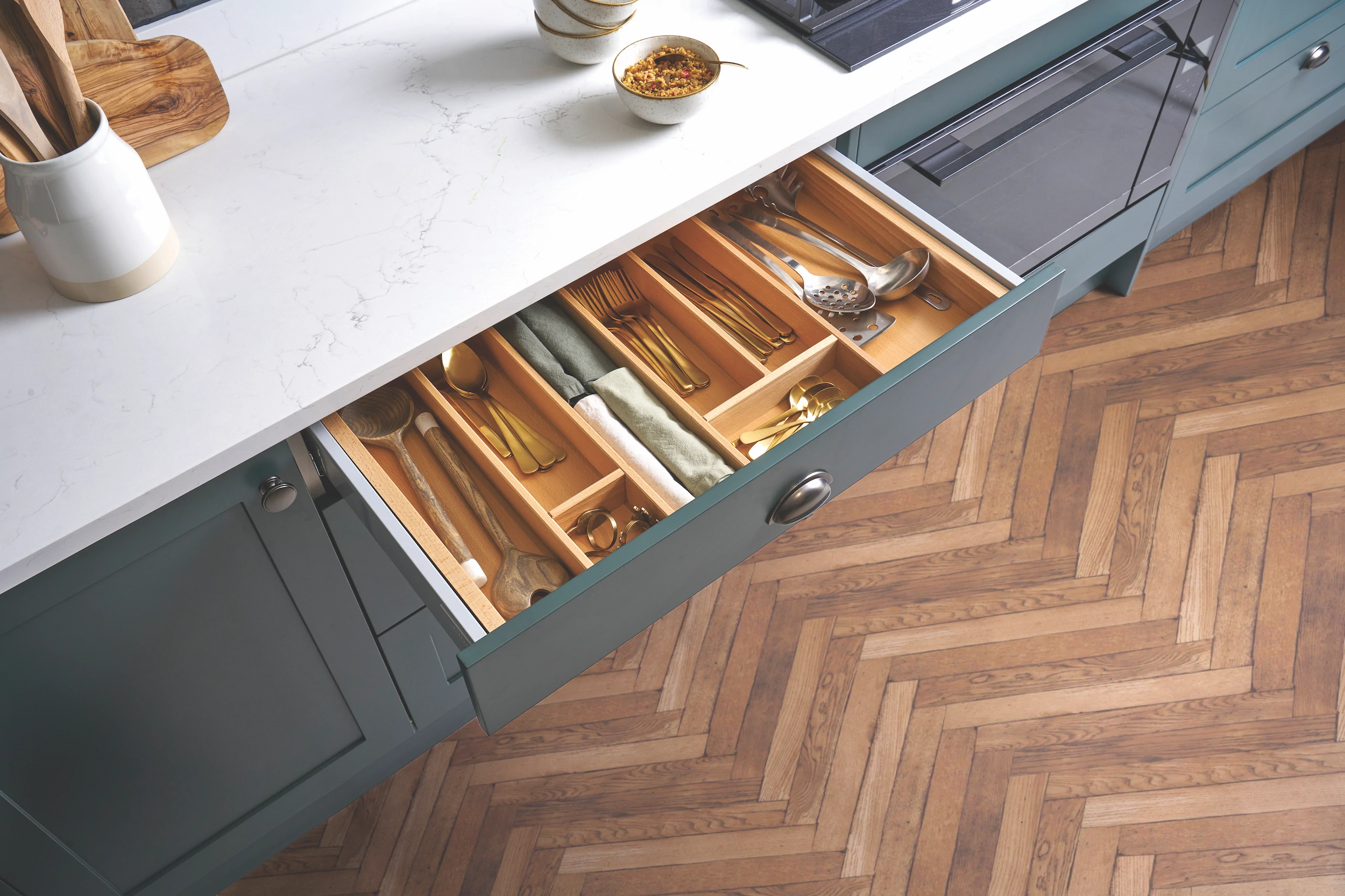 Cutlery drawer with solid oak dividers above a herringbone floor
