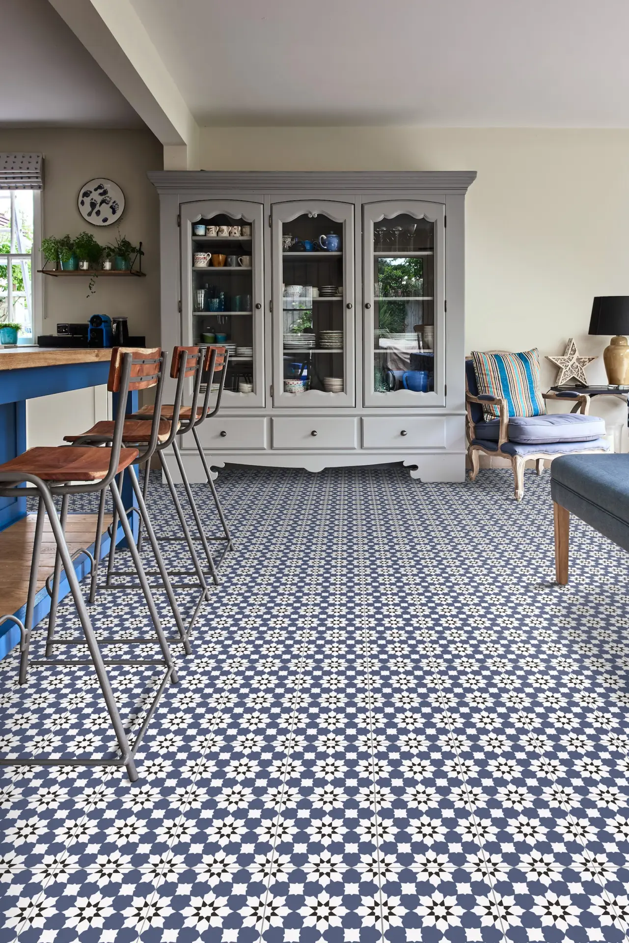 Open plan room with blue patterned floor tiles and glazed dresser