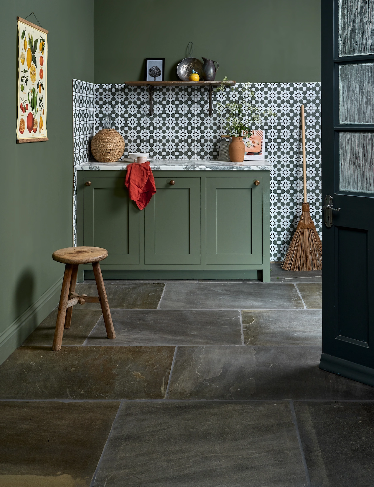 Green utility room with patterned wall tiles and slate flooring