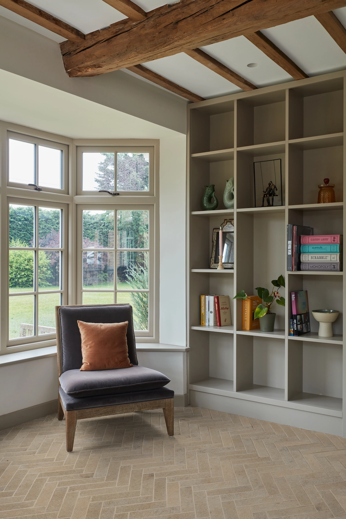 Fitted alcove shelving with reading chair and bay window