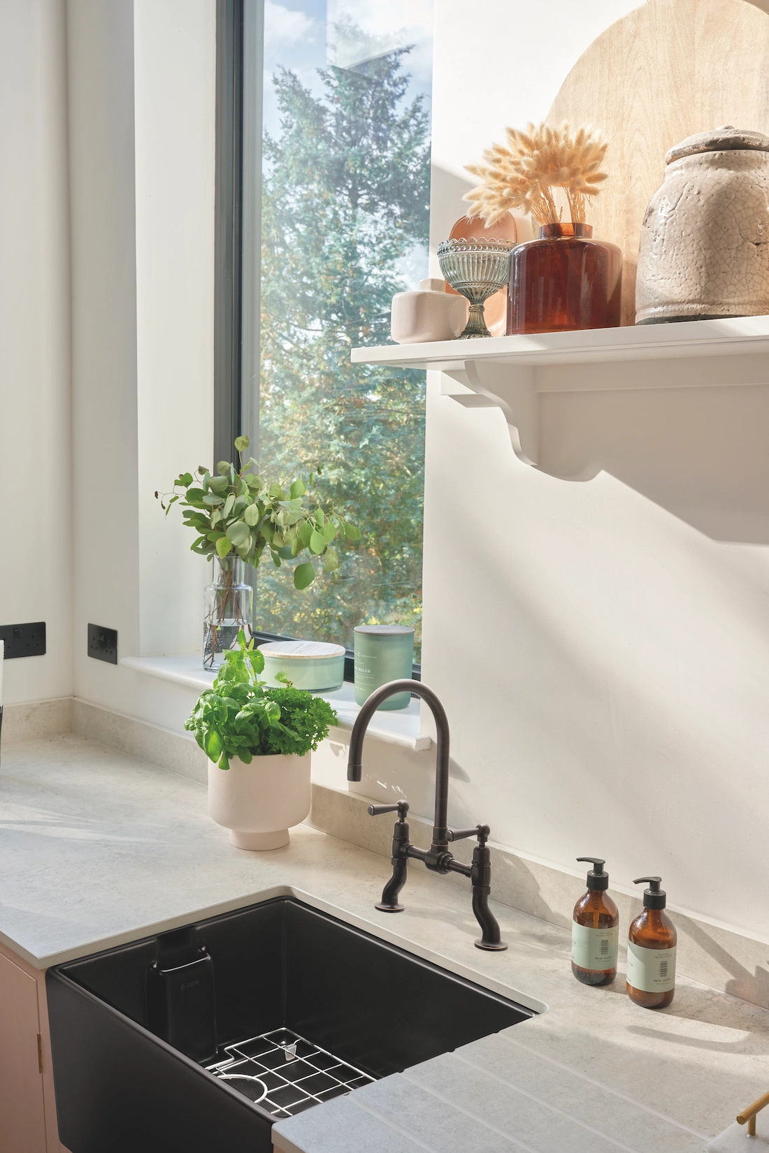 Utility room with black undermount sink and window shelf