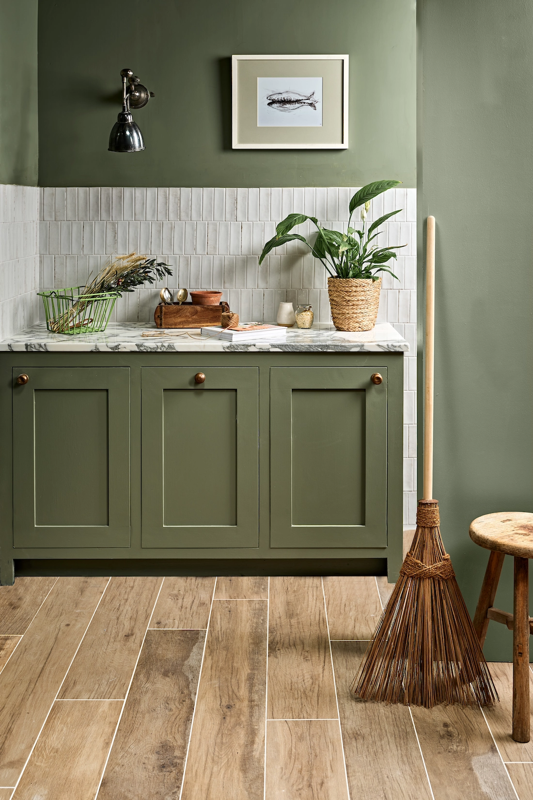 Green utility room with butler sink and wood effect flooring