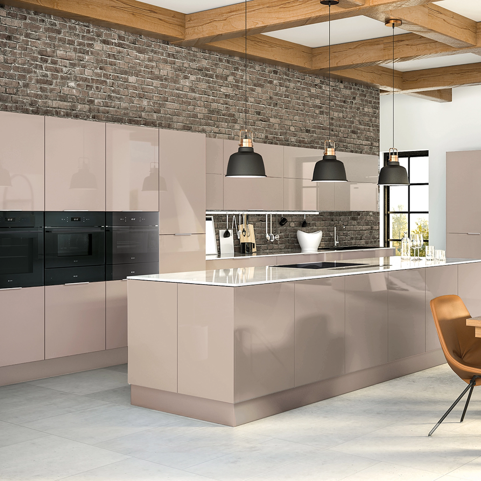 Blush gloss slab kitchen with island and exposed brick wall