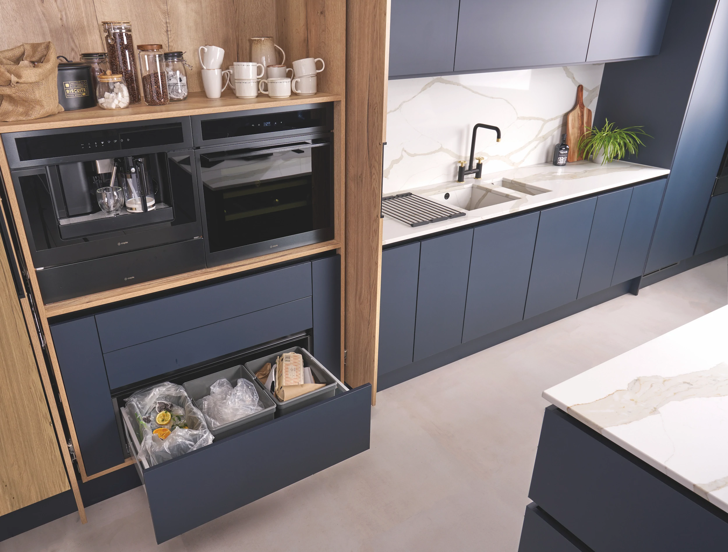 Deep pan drawer with internal storage in a navy kitchen