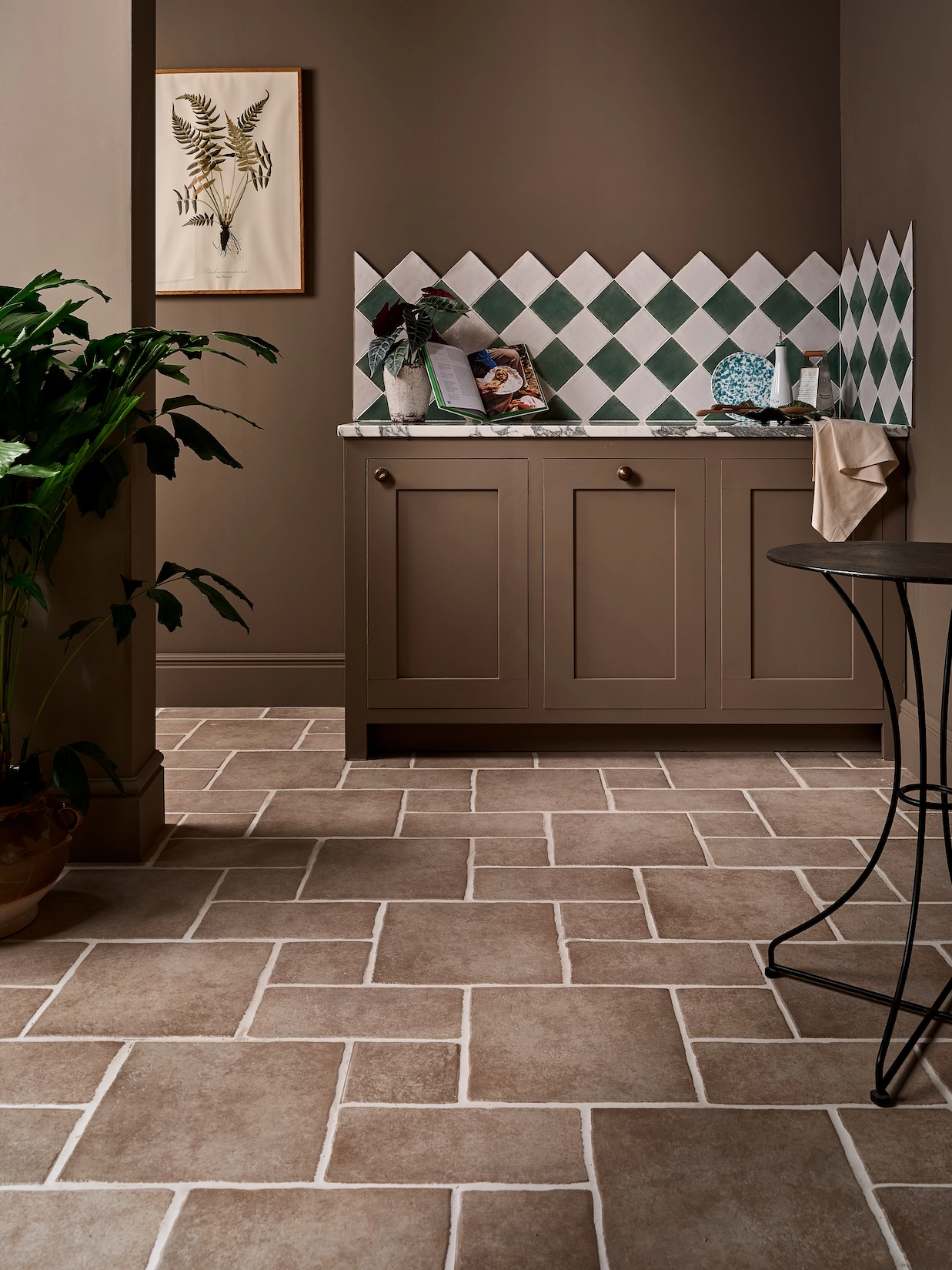 Utility room with harlequin tiled splashback and brick effect floor