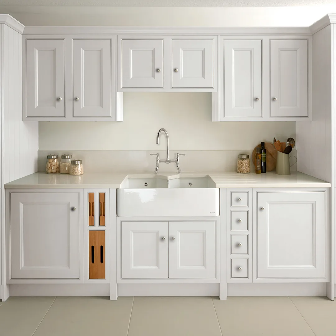 Cream Shaker kitchen with a ceramic belfast sink and brushed brass mixer tap