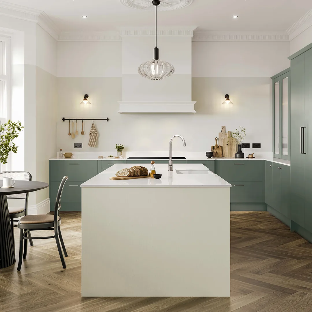 Light kitchen with a central island, pendant lighting, open shelving and sage green base units