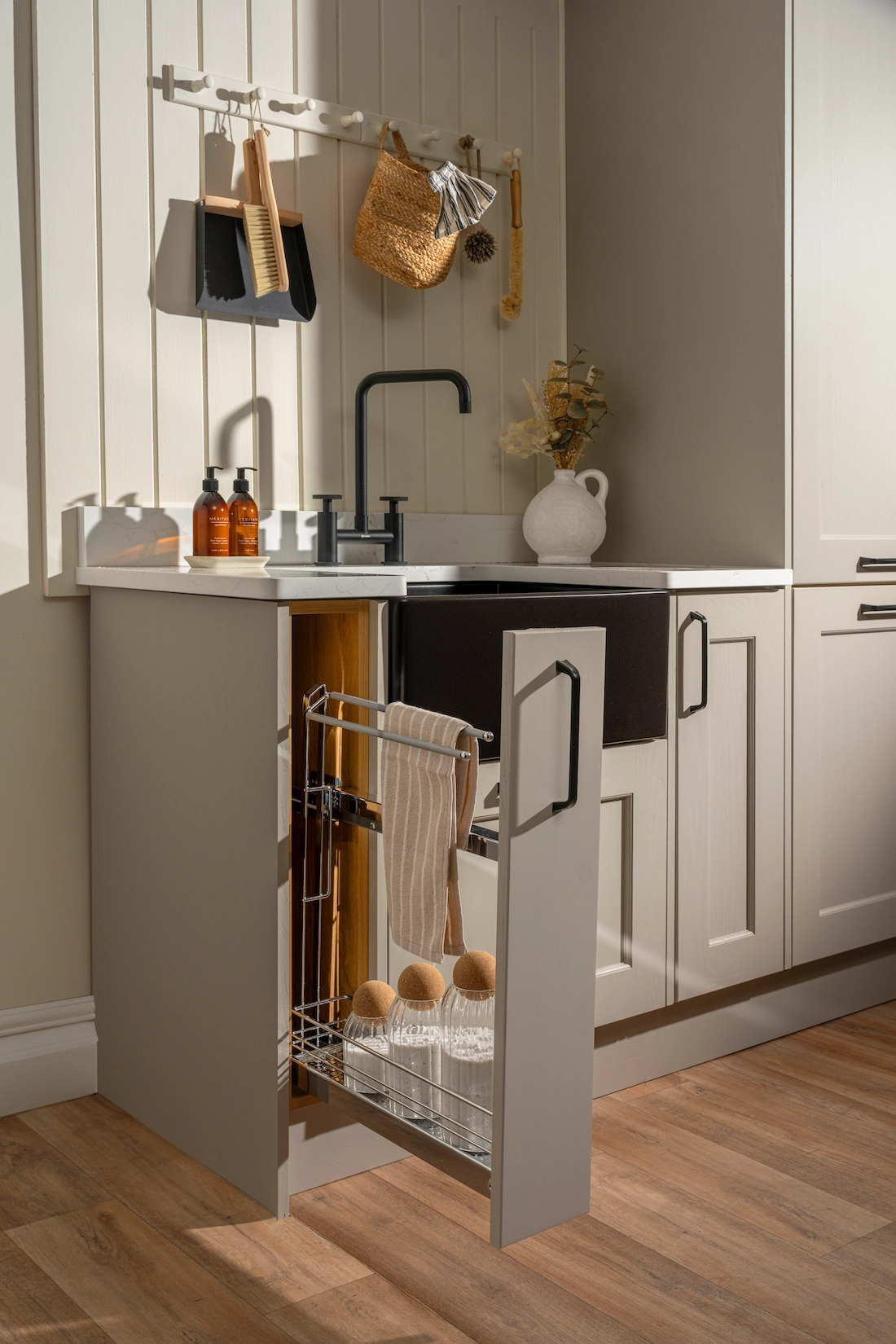 Utility cabinet with pull-out cleaning storage