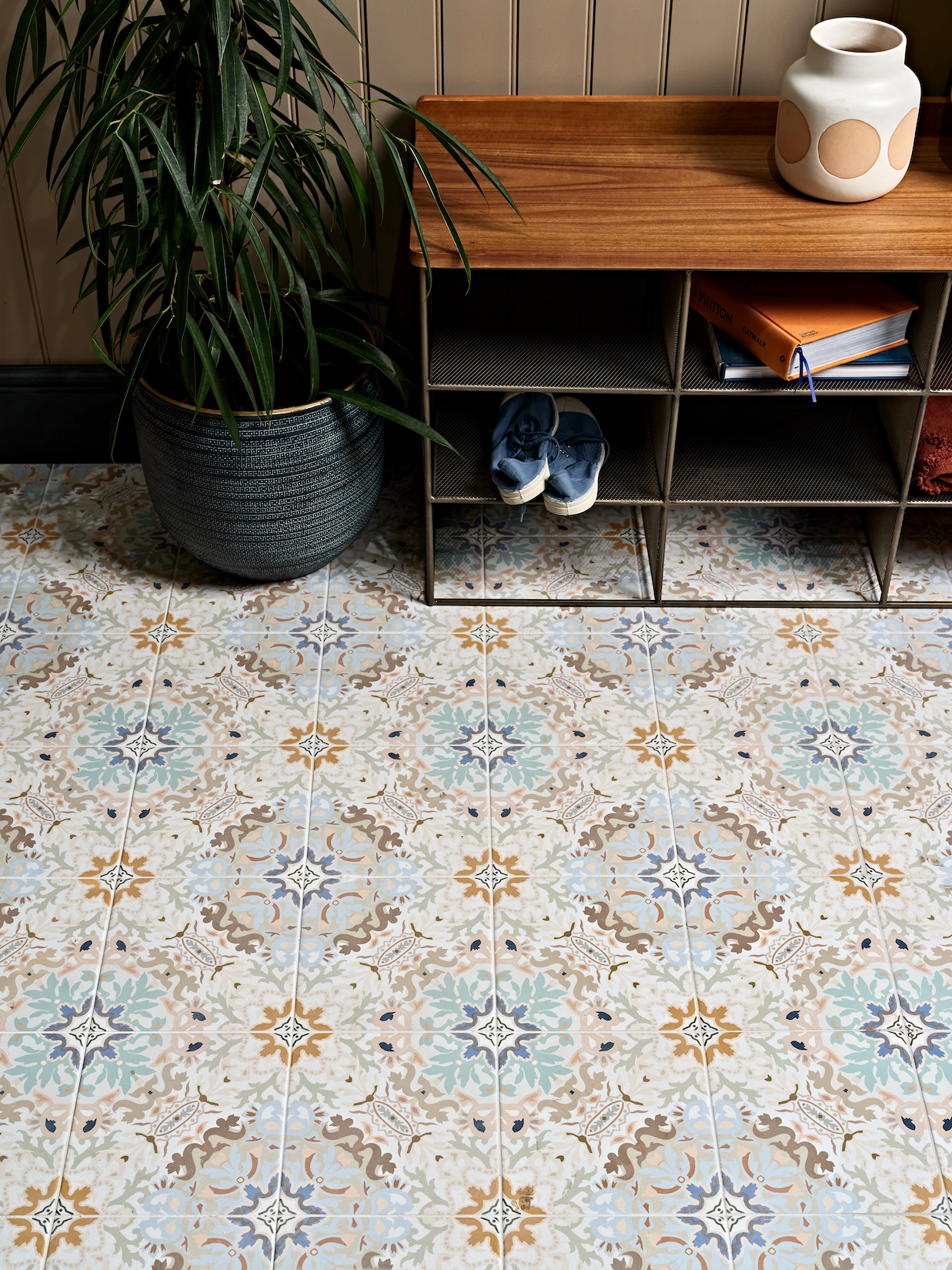 Patterned encaustic floor tiles with shoe storage bench