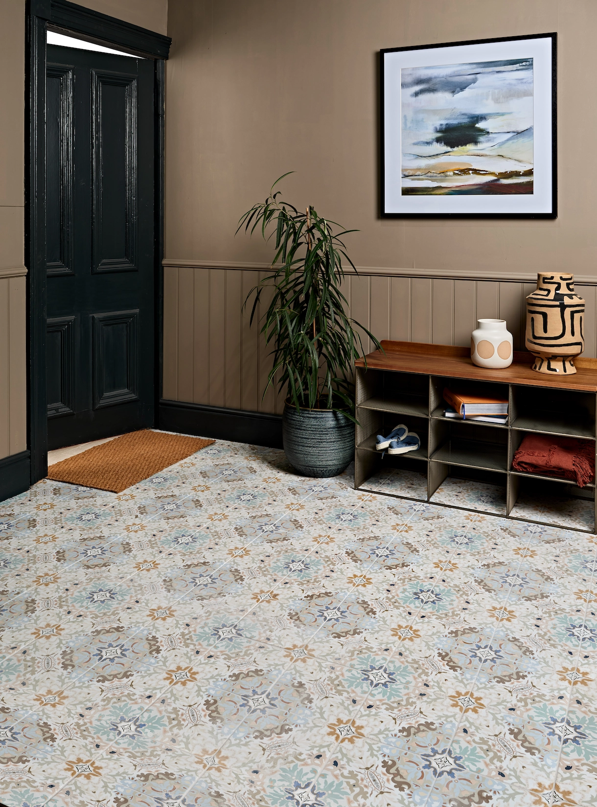 Boot room with patterned tiled floor and timber bench