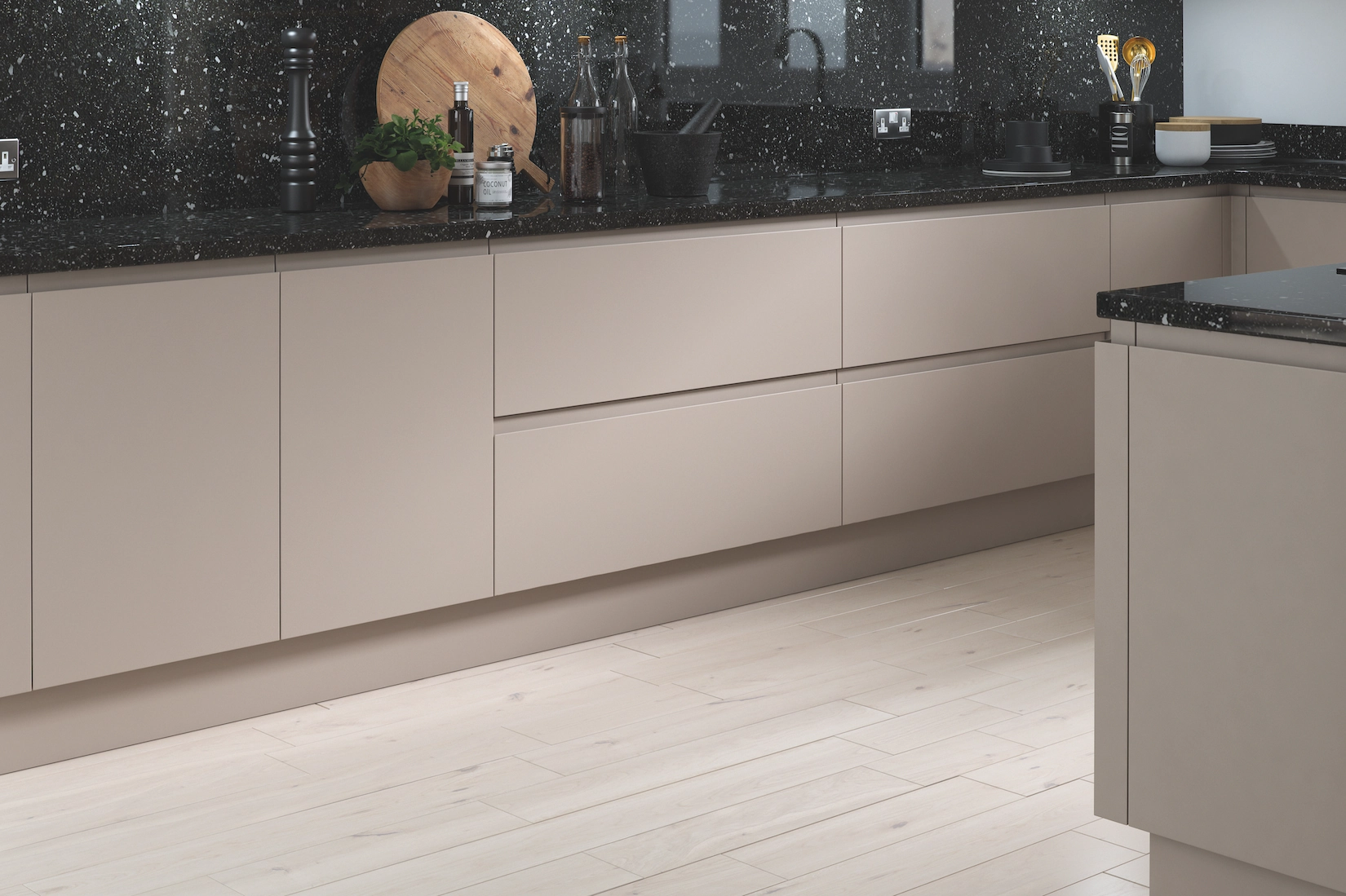 Handleless kitchen in stone with speckled granite worktop
