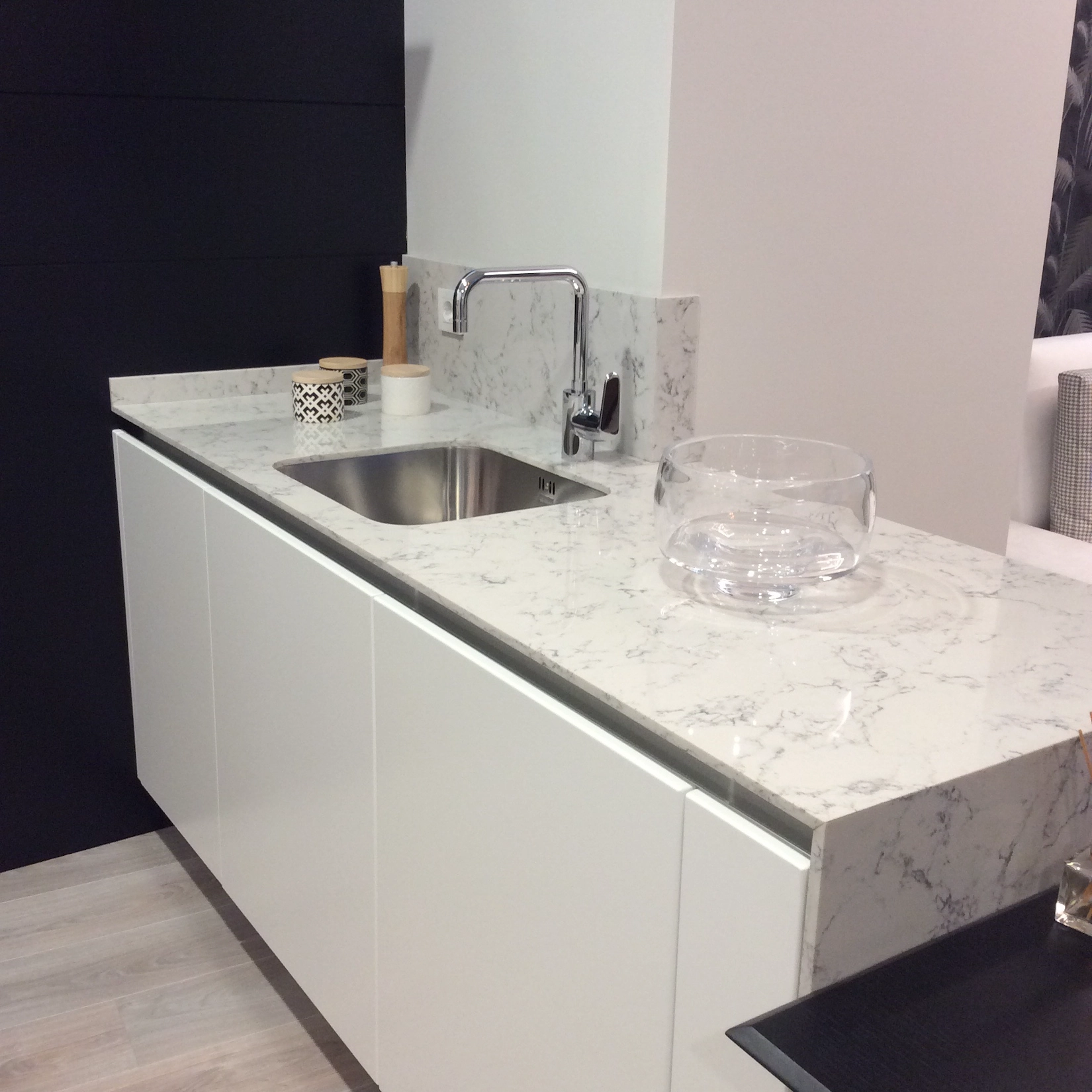 White handleless kitchen with marble worktop and navy wall