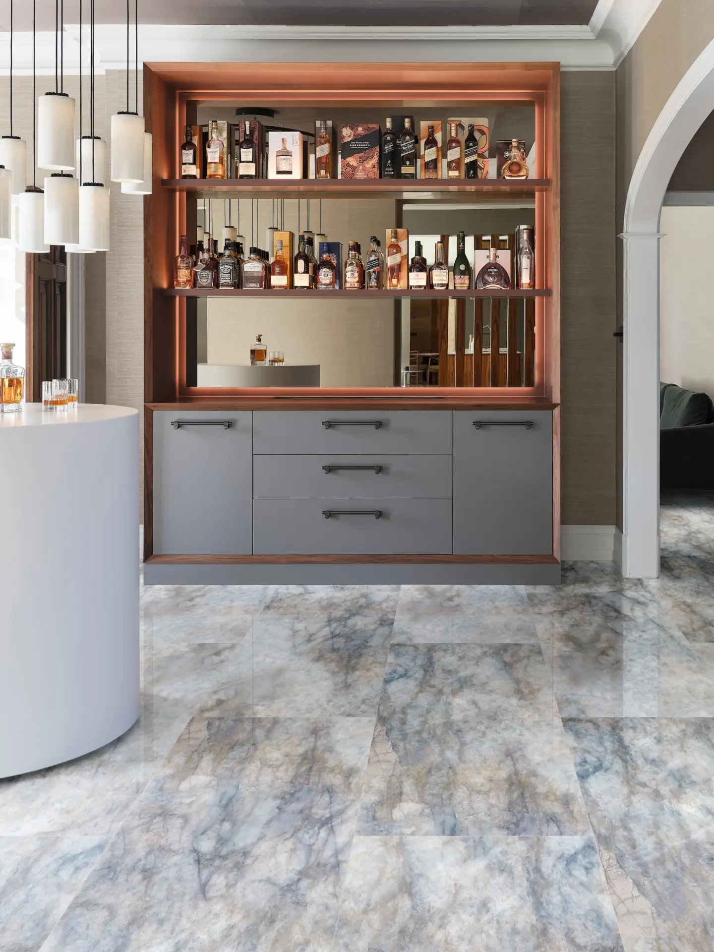 Fitted drinks cabinet in timber with marble effect flooring