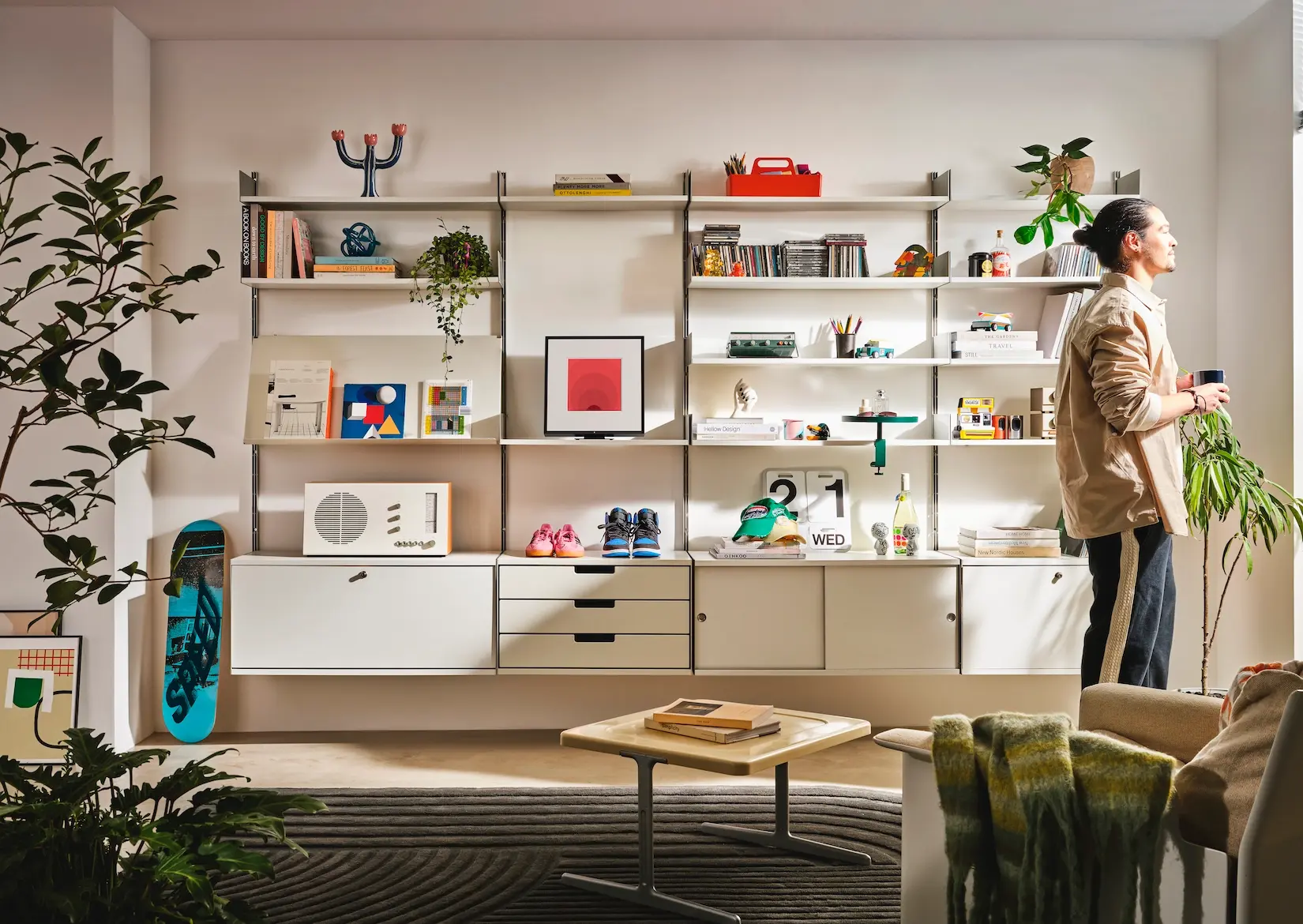 Modular wall shelving system with desk and display objects