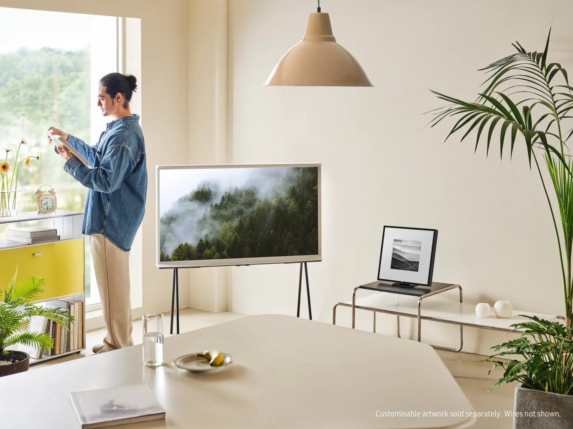 Dining space with wall-mounted television and pendant light