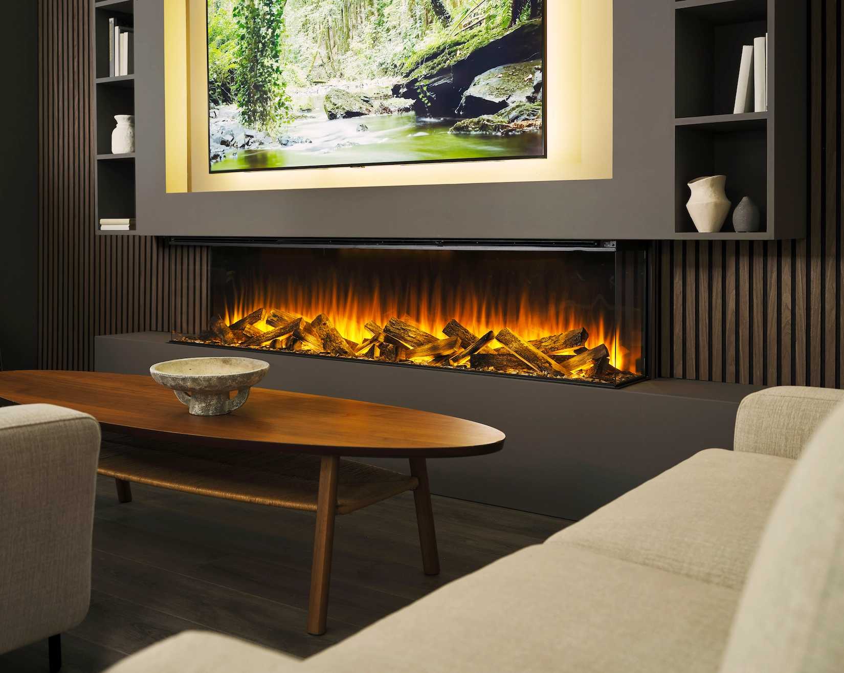 Dark media wall with linear electric fire and lit display niches