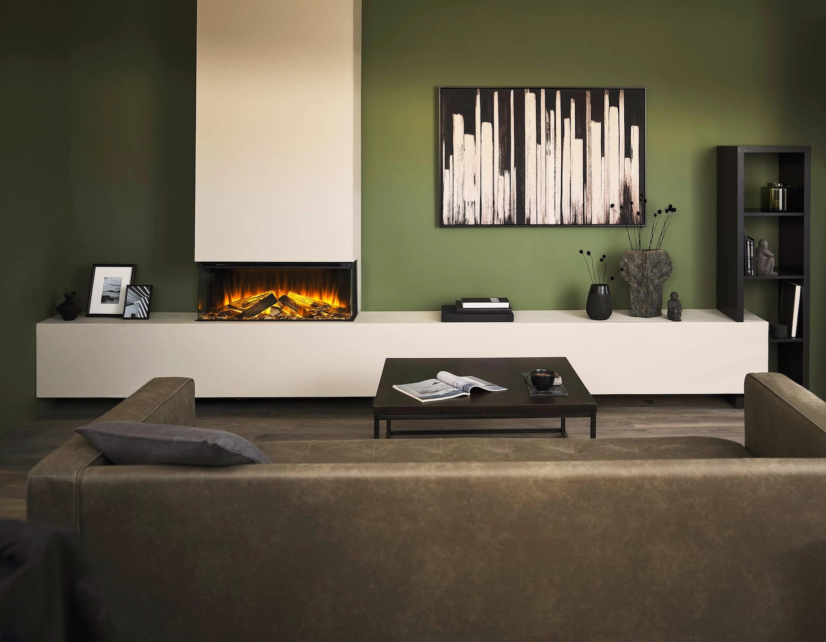 Living room with linear fire, olive walls and low seating