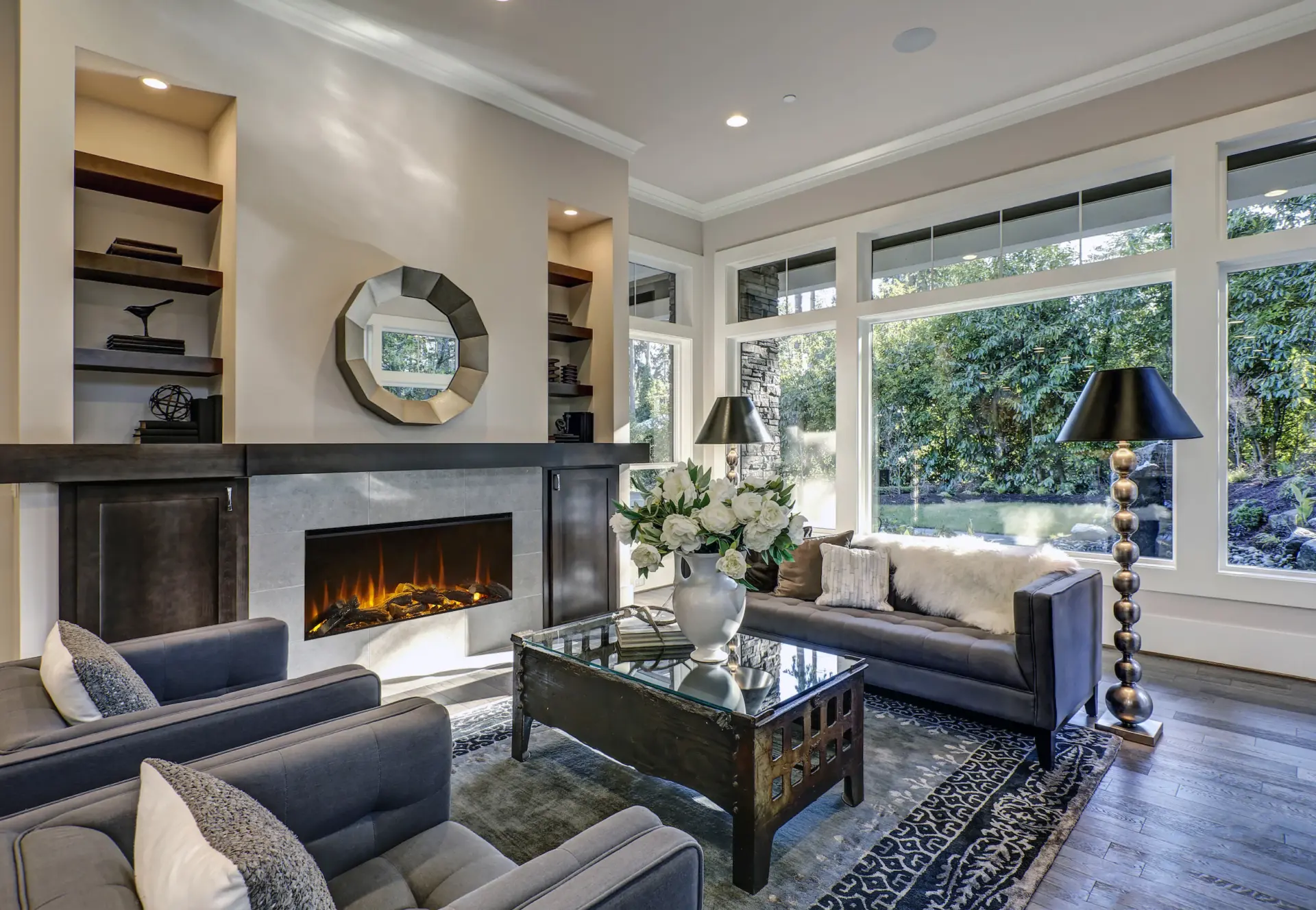 Living room with linear fire, bay window and grey sofas