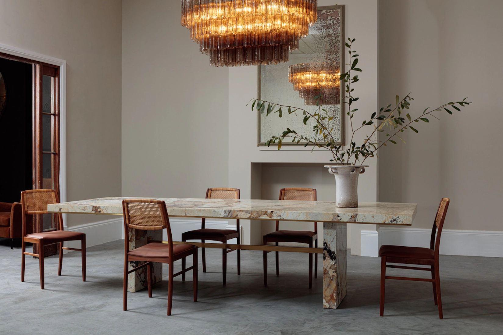 Dining room with marble table and brass chandelier