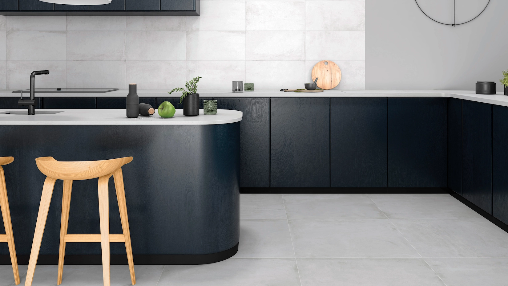 Navy handleless kitchen with curved island and marble floor