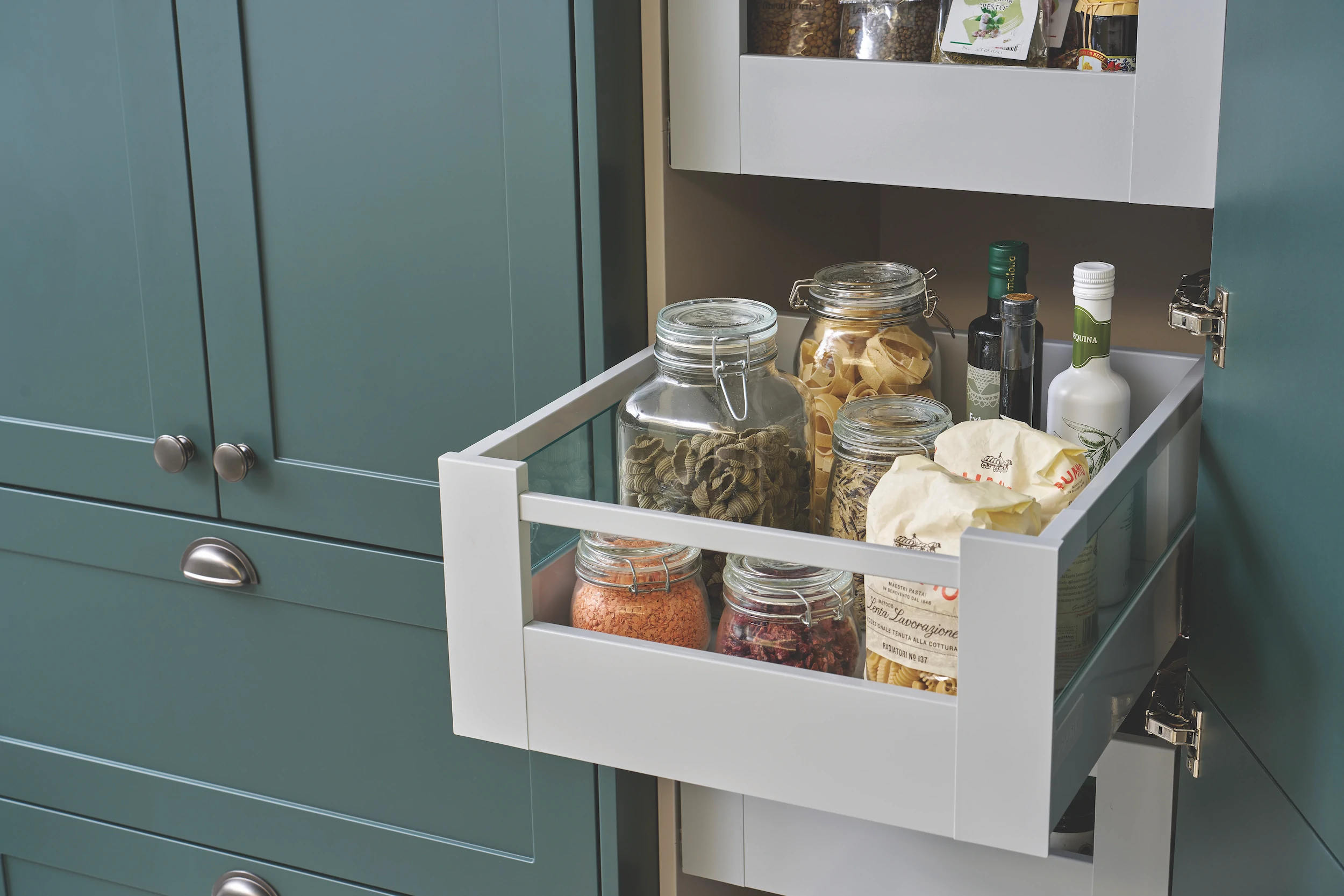 Tall pull-out larder unit filled with glass storage jars