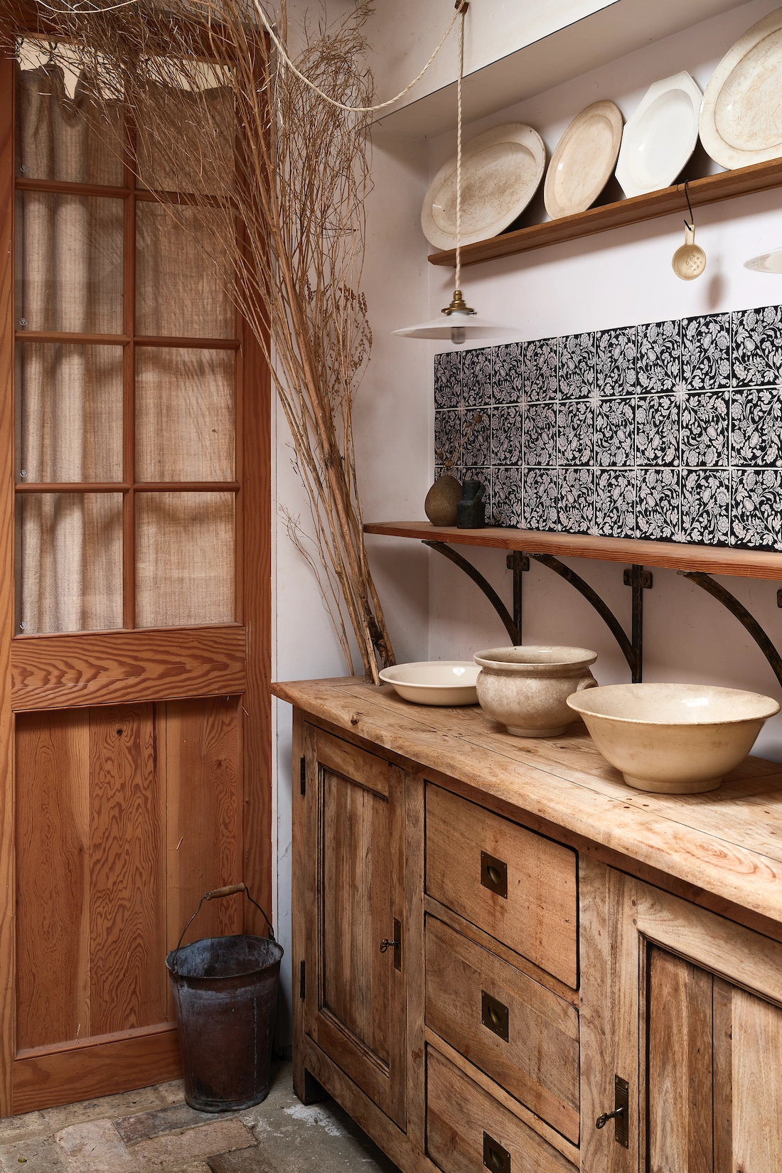 Timber utility dresser with open shelving and patterned splashback