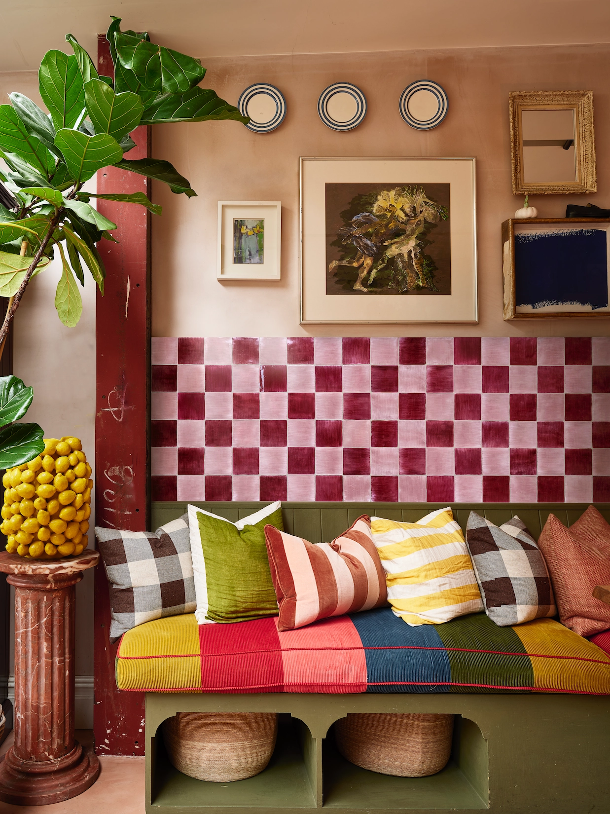 Boot room bench with pink chequerboard tiles and gallery wall