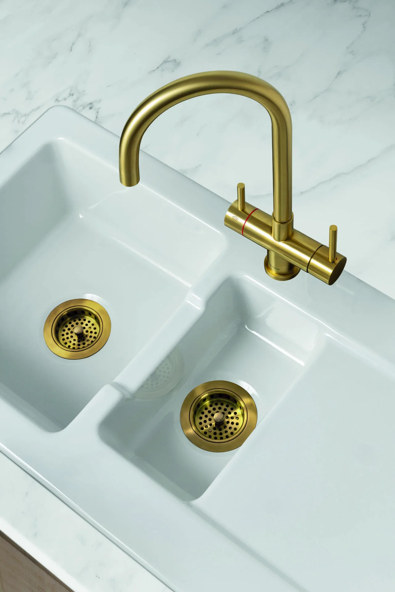 White ceramic double butler sink with a brass bridge tap