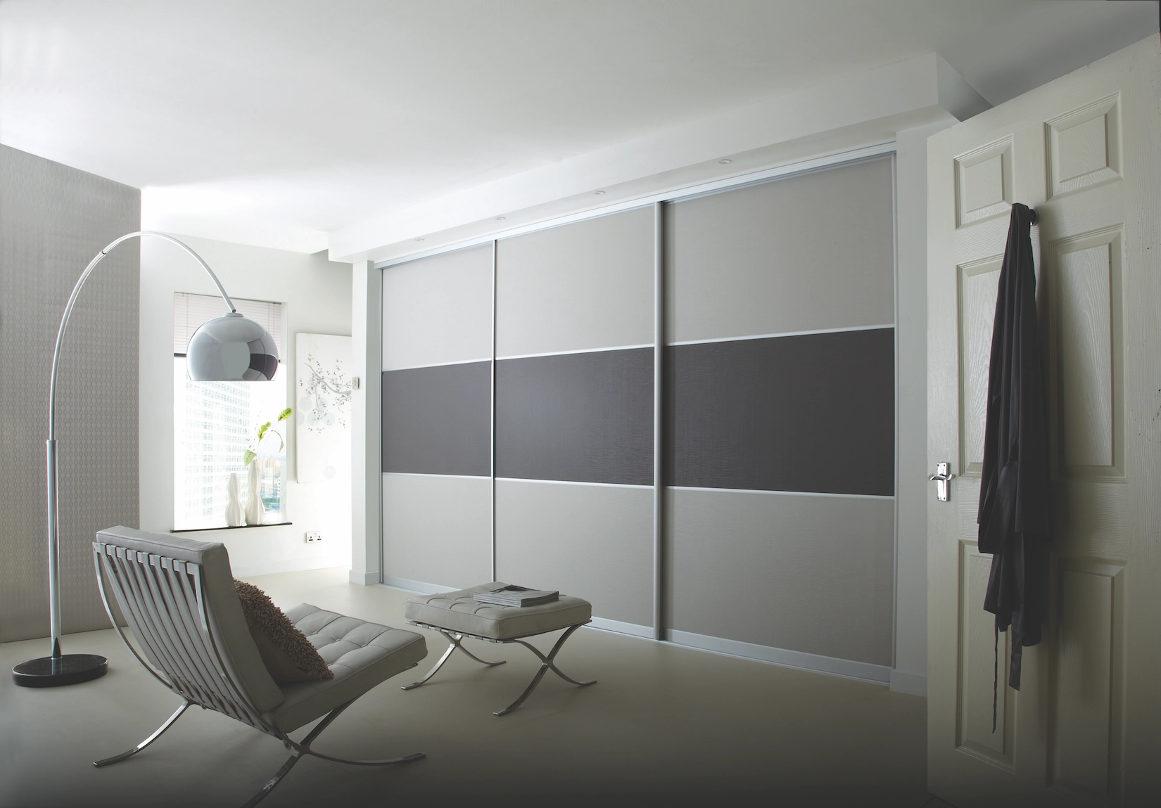 Grey and white sliding wardrobe doors in a bedroom