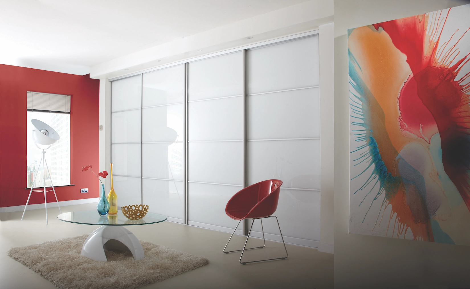 White sliding wardrobe doors in a bedroom with artwork