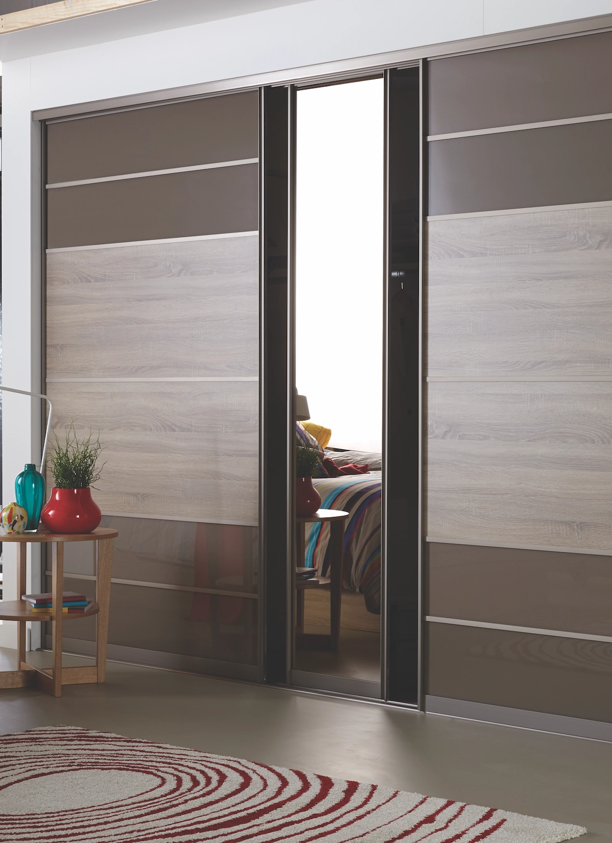 Timber and grey sliding wardrobe doors with mirrored panel