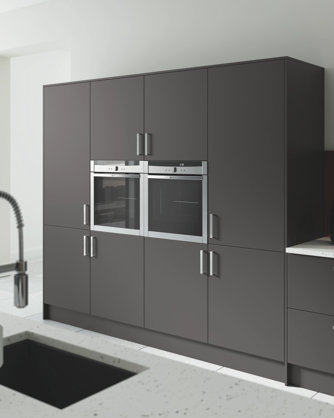 Dark grey slab tall units with integrated ovens