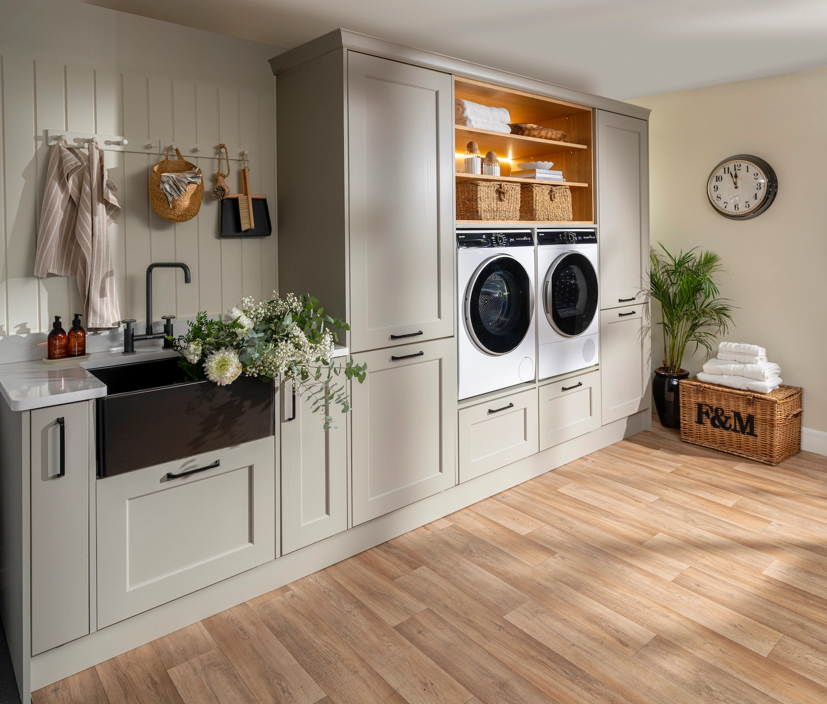 Utility room with butler sink, laundry appliances and oak flooring