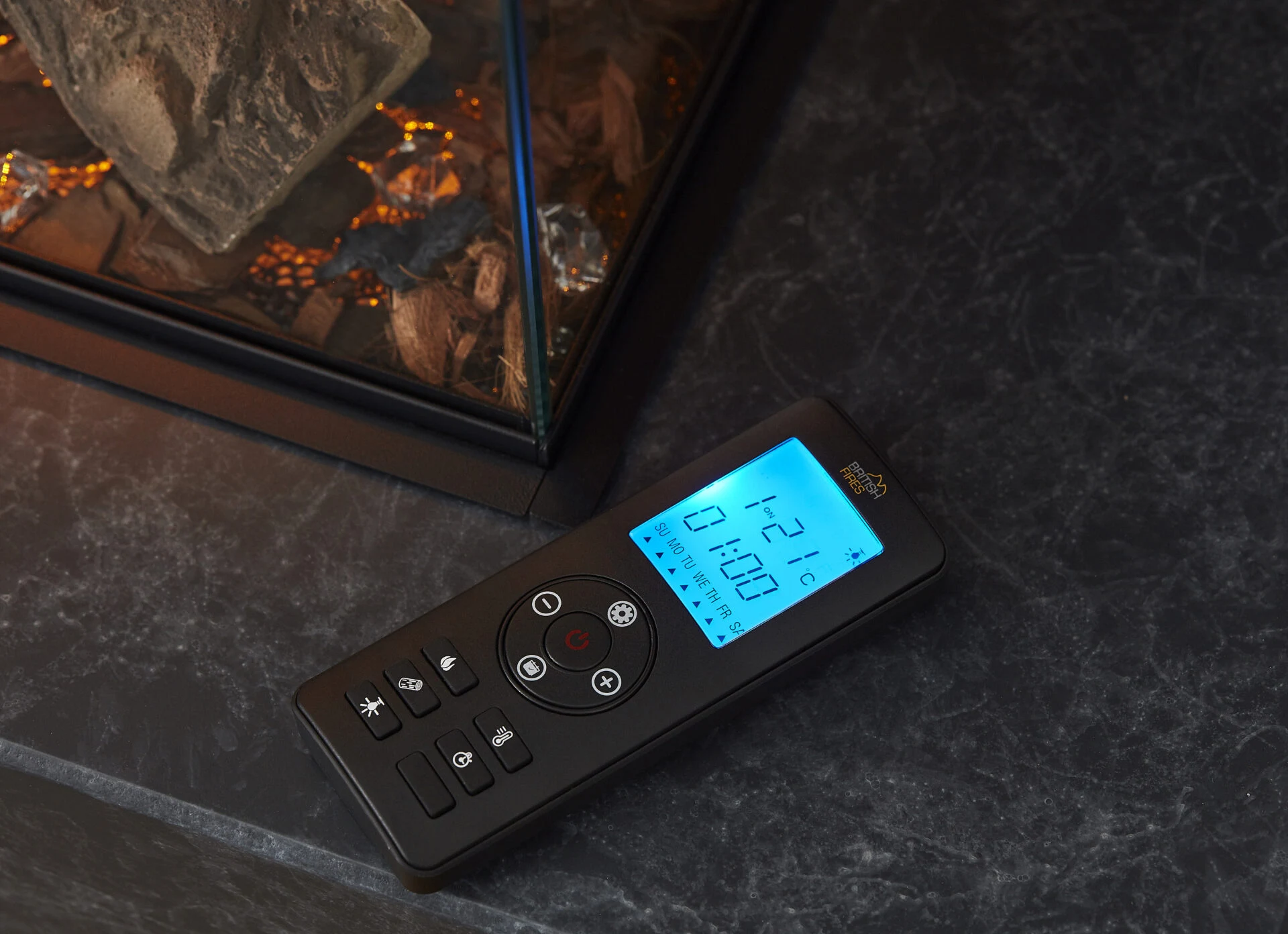 Fireplace remote control on dark stone worktop