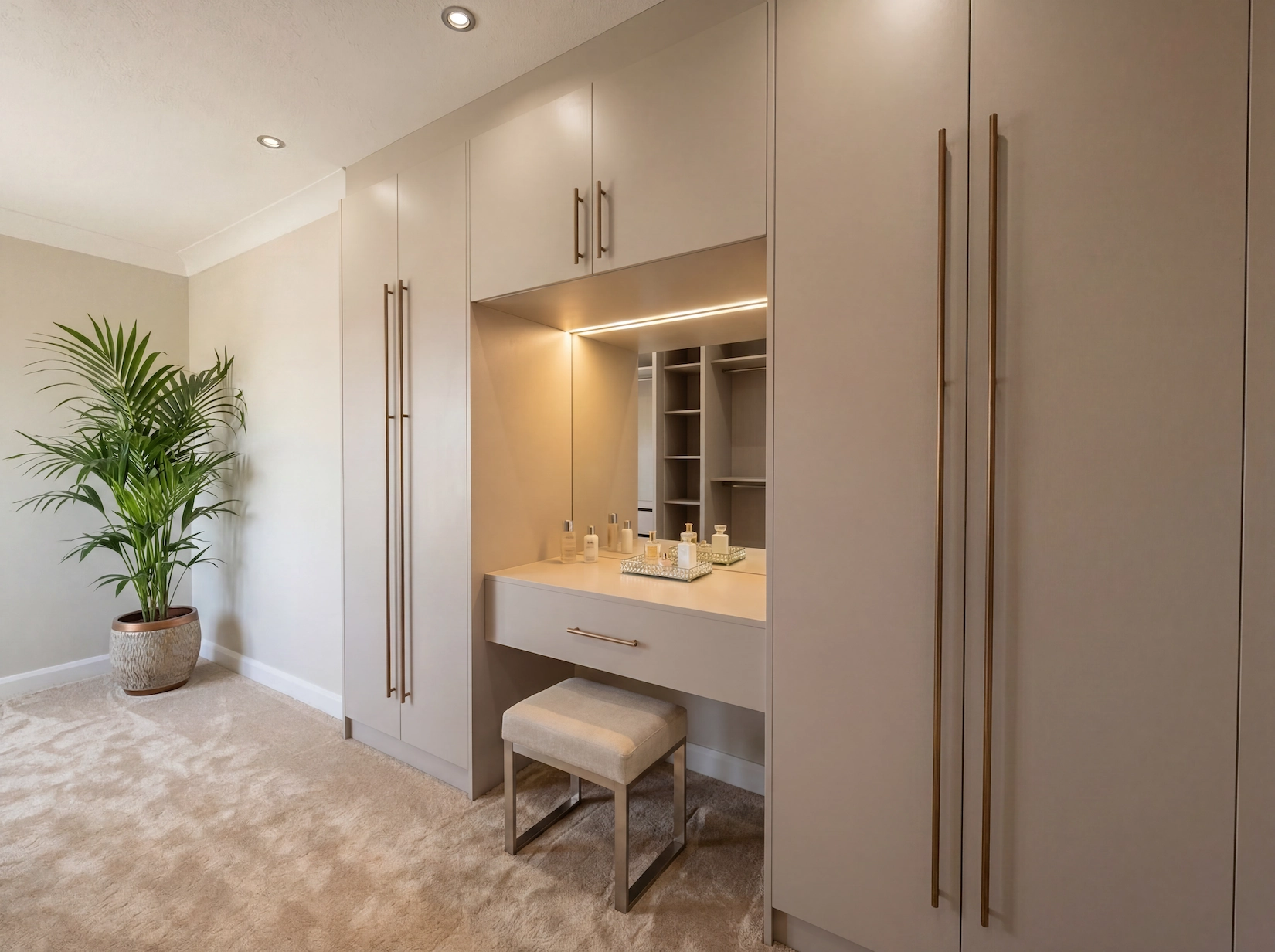 Fitted bedroom with dressing table and full height wardrobes