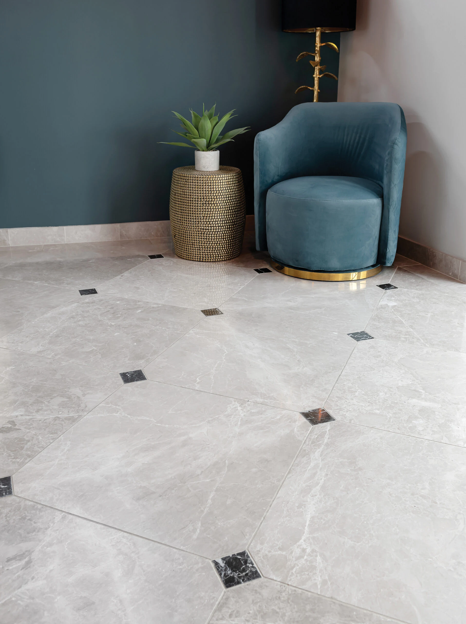 Grey marble effect floor tiles with teal armchair