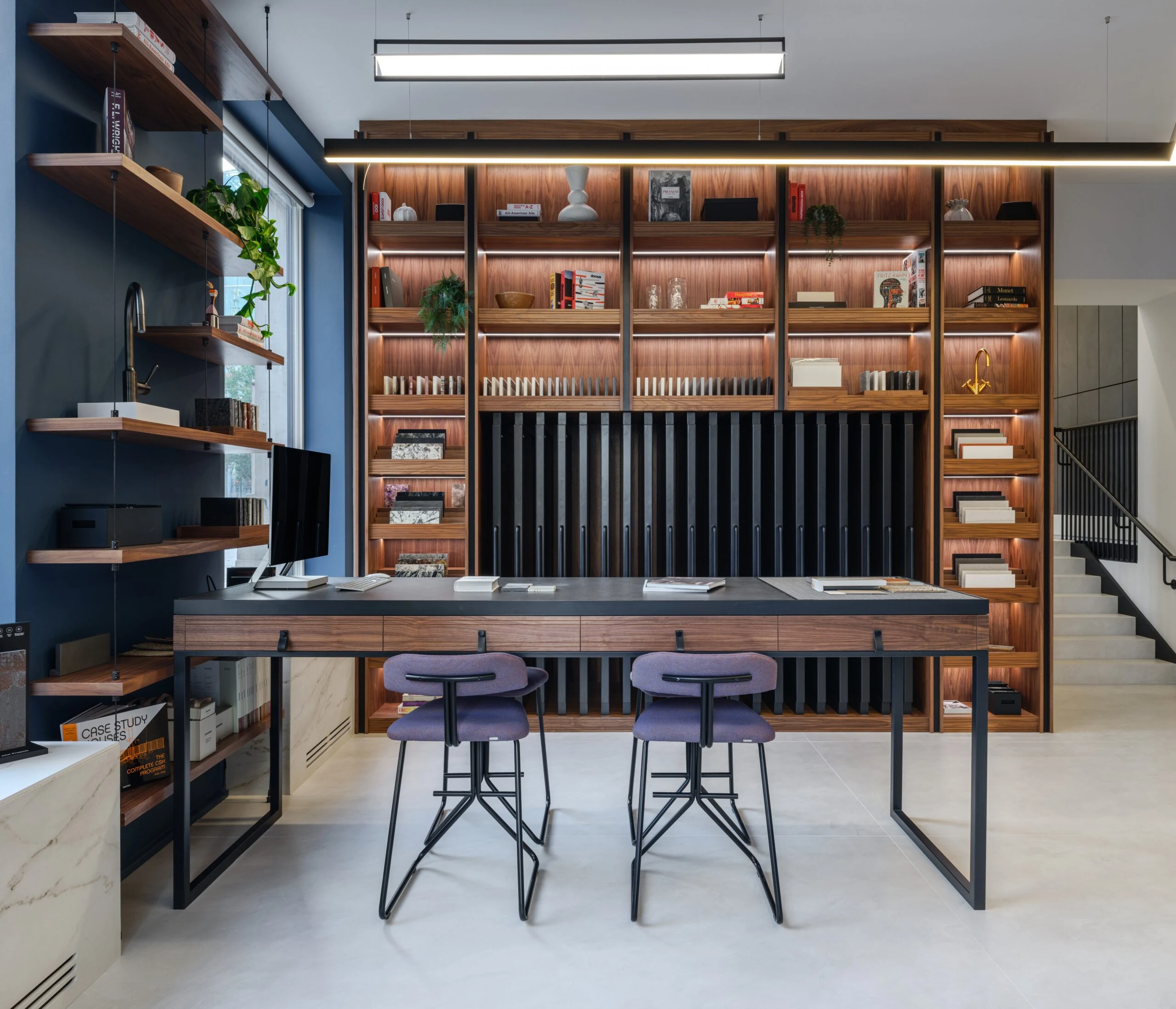 Home office with copper toned shelving and fitted desk