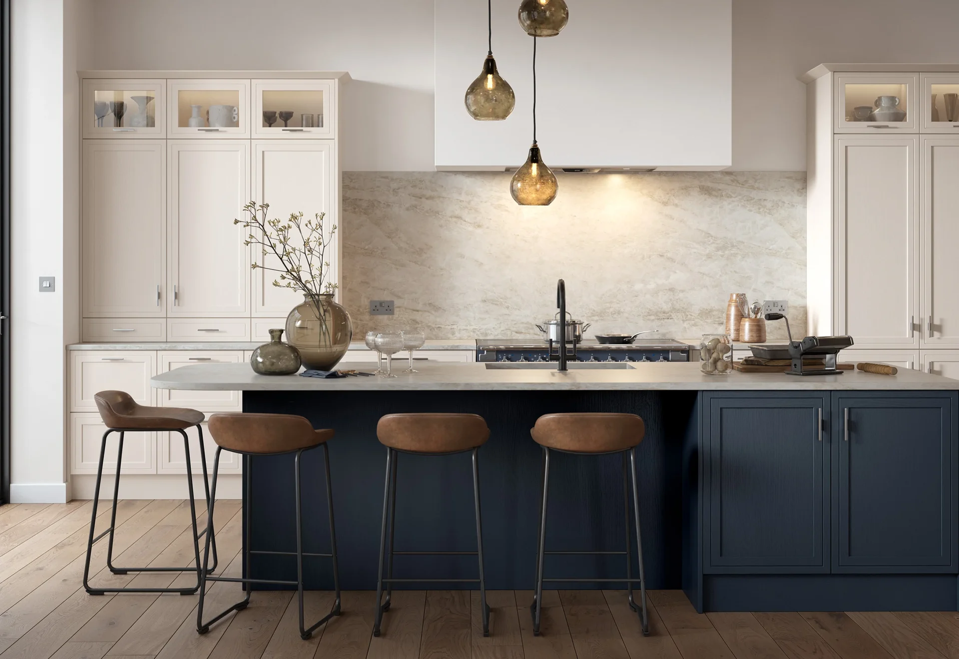Kitchen with navy island, cream cabinetry and pendant lights