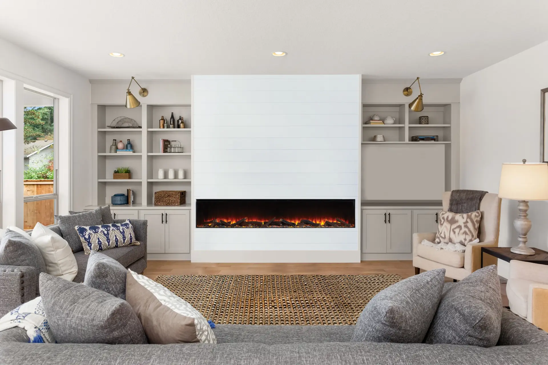Living room media wall with electric fire and built-in shelving