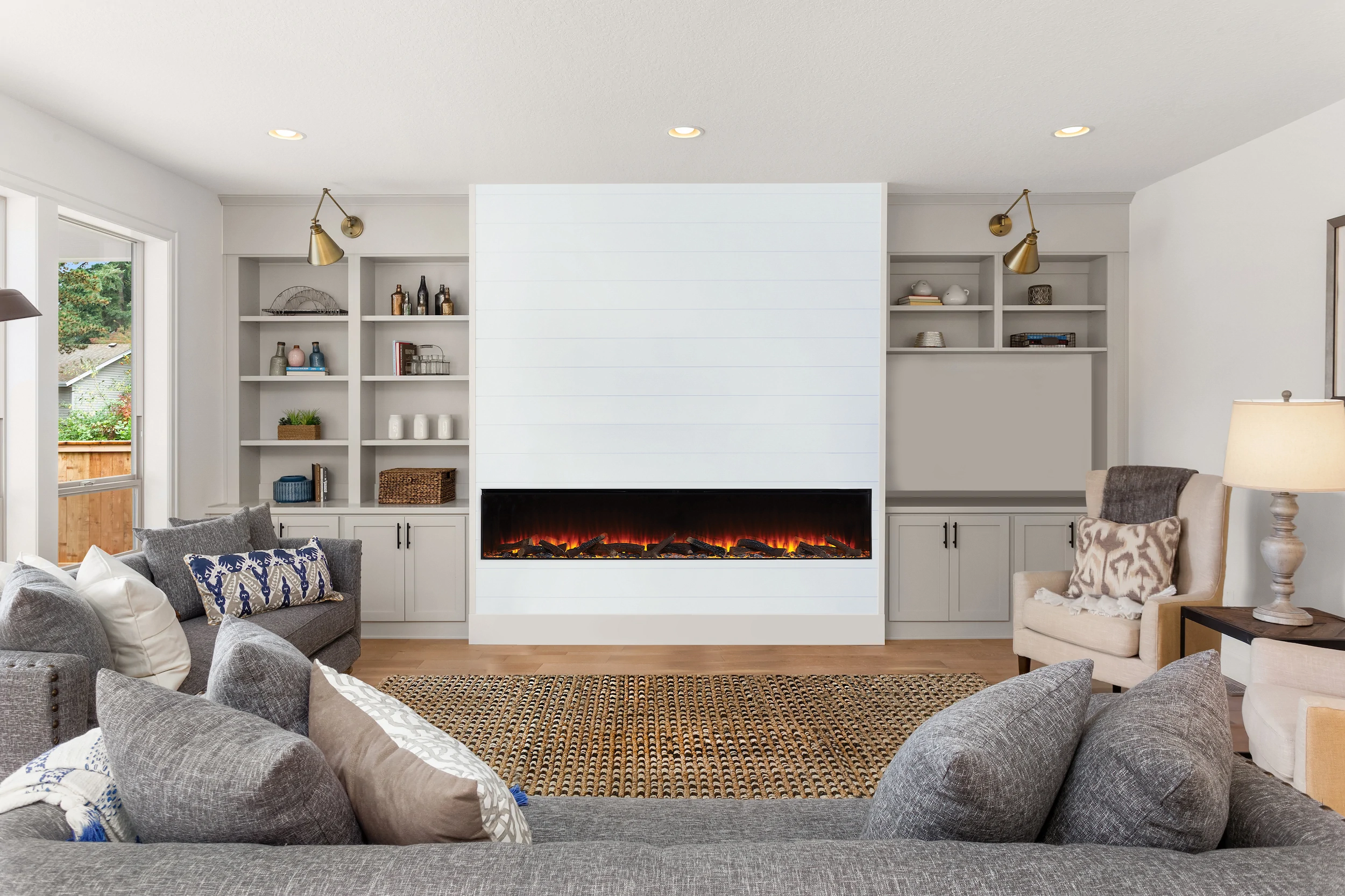 Living room media wall with electric fire and built-in shelving